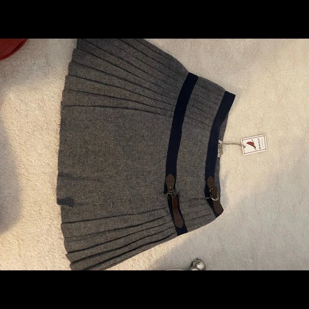 Gant pleated M.B. Kilt in grey with navy and leather clasp. Origins $398.00. - Picture 2 of 2